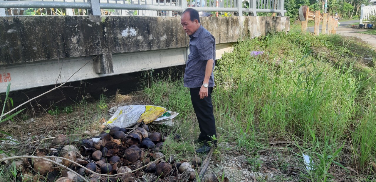 Đồng chí Huỳnh Văn Dũng - Giám đốc game bài đổi thưởng
  nhặt từng vỏ dừa lật úp lại để không còn chứa nước mưa.